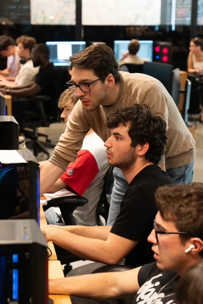 Docente affianca gli studenti alle postazioni nel laboratorio di animazione