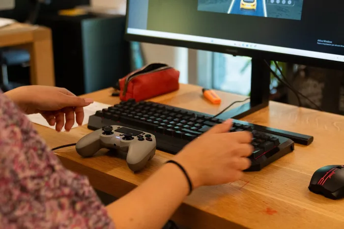 Studenti testano un videogioco con controller e tastiera